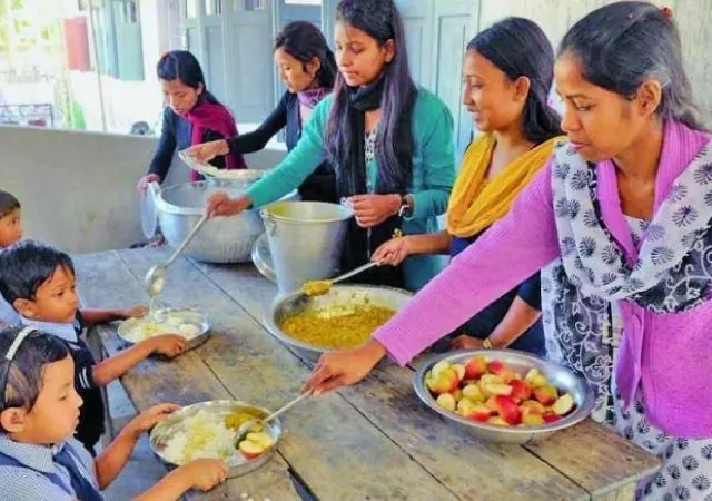 Volunteers preparing food in a community kitchen