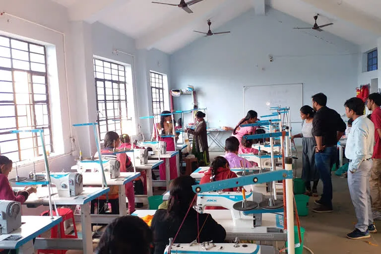 Women receiving training in a tailoring and skill training class